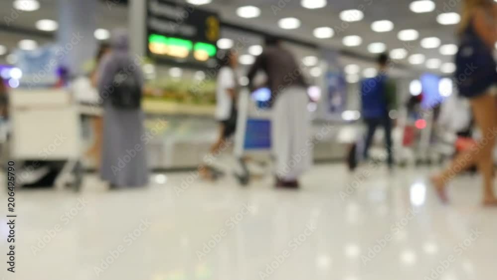 Slow motion blur people or tourist or passenger walking at airport terminal - background rush travel people in airport concept Slow motion blur people or tourist or passenger walking at airport terminal - background rush travel people in airport concept