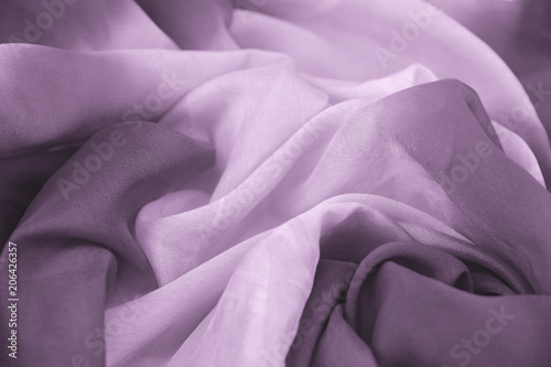 The texture of the satin fabric of lilac color for the background 