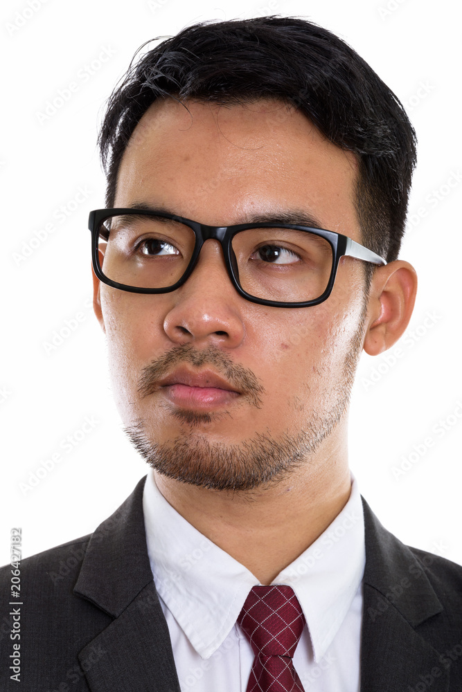 Face of young Asian businessman thinking while wearing eyeglasse Face of young Asian businessman thinking while wearing eyeglasse