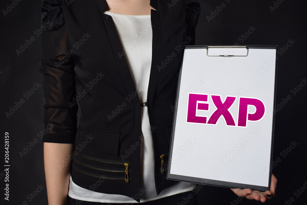 In the hands of a businessman a notebook with the inscription:EXP In the hands of a businessman a notebook with the inscription:EXP
