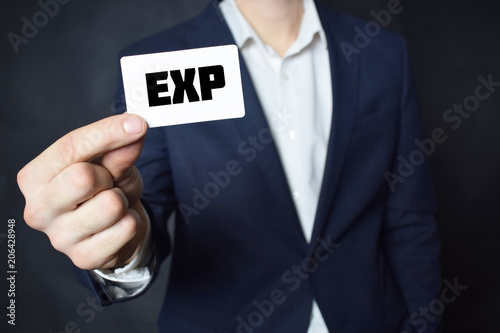 Businessman shows business card with the inscription:EXP