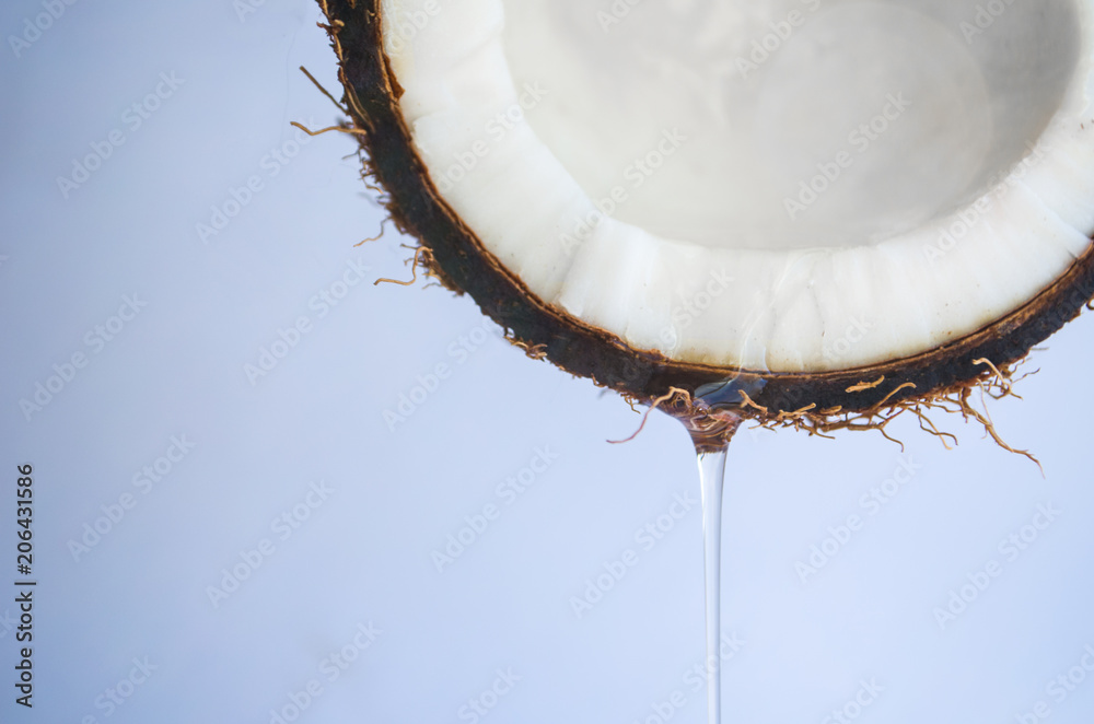 coconut oil flowing from the coconut on white background coconut oil flowing from the coconut on white background