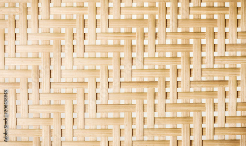 Woven bamboo strips pattern close up. Wickerwork bamboo texture background.