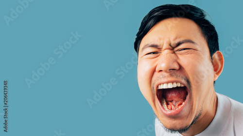 Face of Asian man shout and scream on isolated background. photo