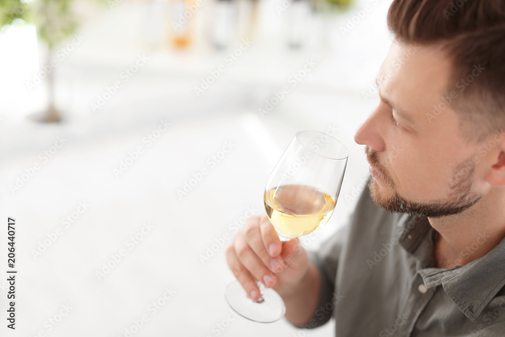 Man with glass of delicious wine indoors Man with glass of delicious wine indoors