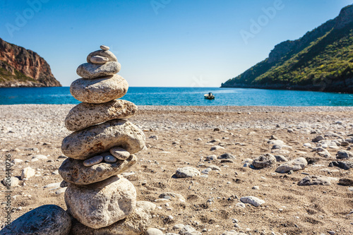 stone stack fireplace with rope on beach