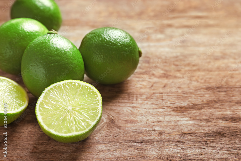 Fresh ripe limes on wooden table. Citrus fruit Fresh ripe limes on wooden table. Citrus fruit