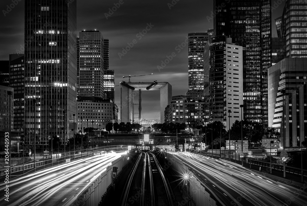 Fototapeta premium Modern city at night with cars light lines.