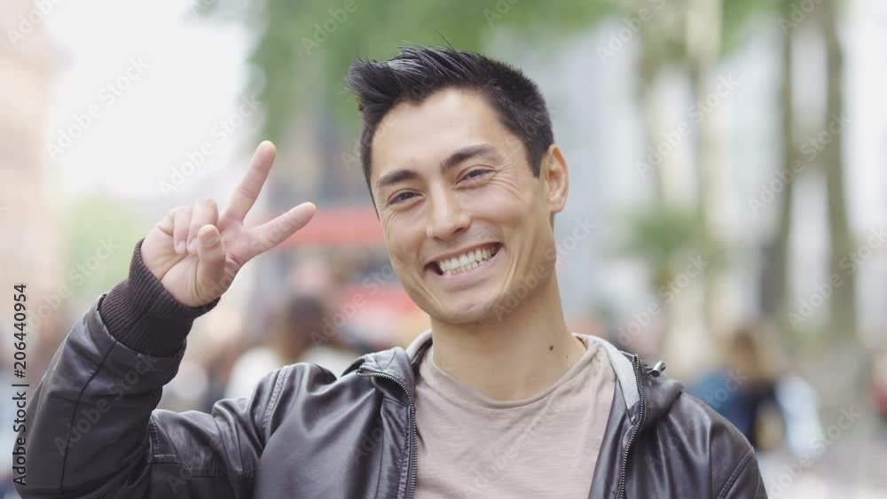 Portrait of smiling happy asian man looking to camera Portrait of smiling happy asian man looking to camera