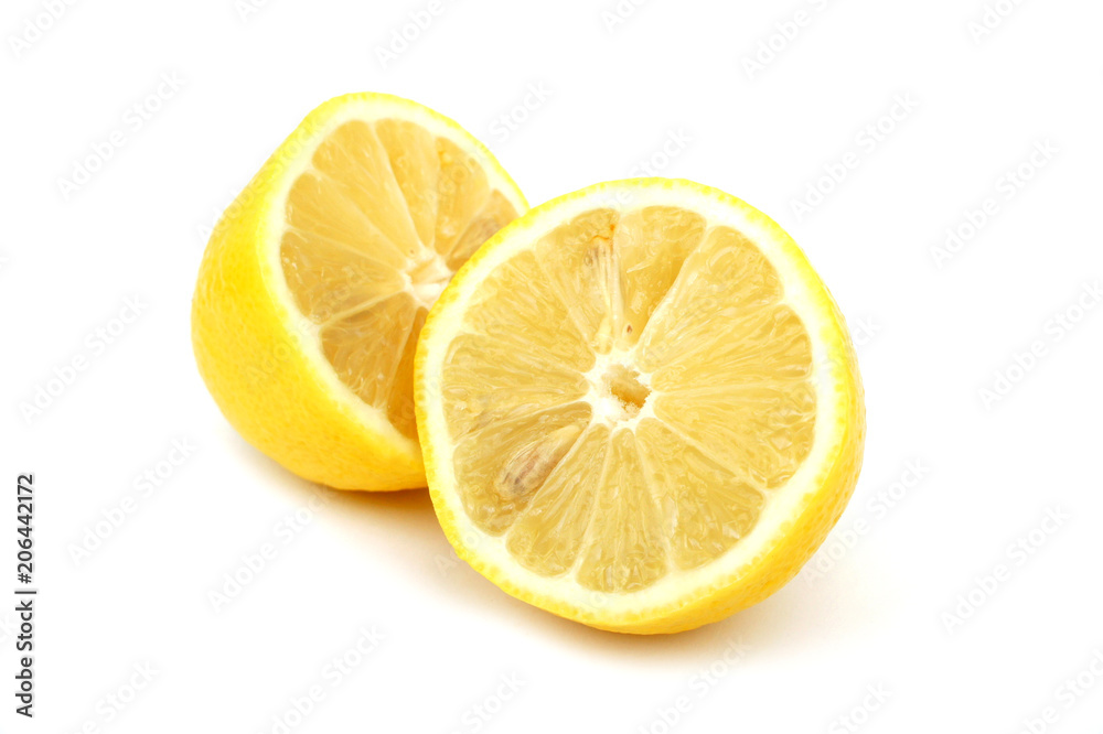Lemon cut into two halves on a white background. Close up. Lemon cut into two halves on a white background. Close up.