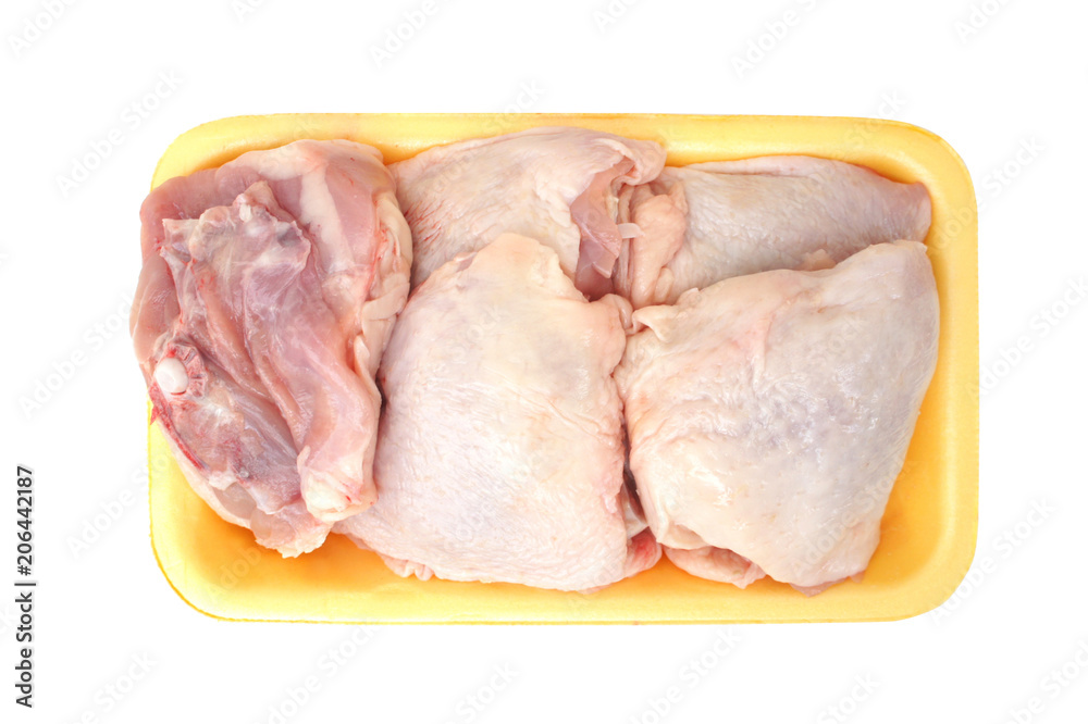 Raw chicken legs in a pack isolated on white background. Top view. Chicken thighs for cooking. 