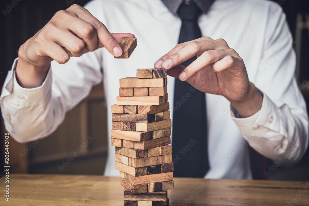 Images of hand of businesspeople placing and pulling wood block on the tower, Alternative risk concept, plan and strategy in business, Risk To Make Business Growth Concept With Wooden Blocks Images of hand of businesspeople placing and pulling wood block on the tower, Alternative risk concept, plan and strategy in business, Risk To Make Business Growth Concept With Wooden Blocks