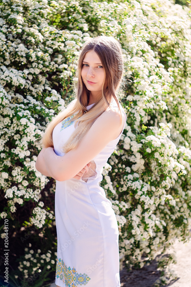 Beautiful young girl fashion model in white dress stands. Beautiful young girl fashion model in white dress stands.