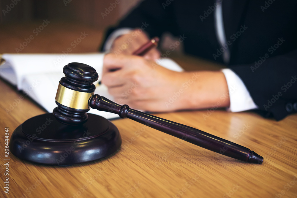 Judge gavel with Justice lawyers, Businessman in suit or lawyer working on a documents. Legal law, advice and justice concept Judge gavel with Justice lawyers, Businessman in suit or lawyer working on a documents. Legal law, advice and justice concept