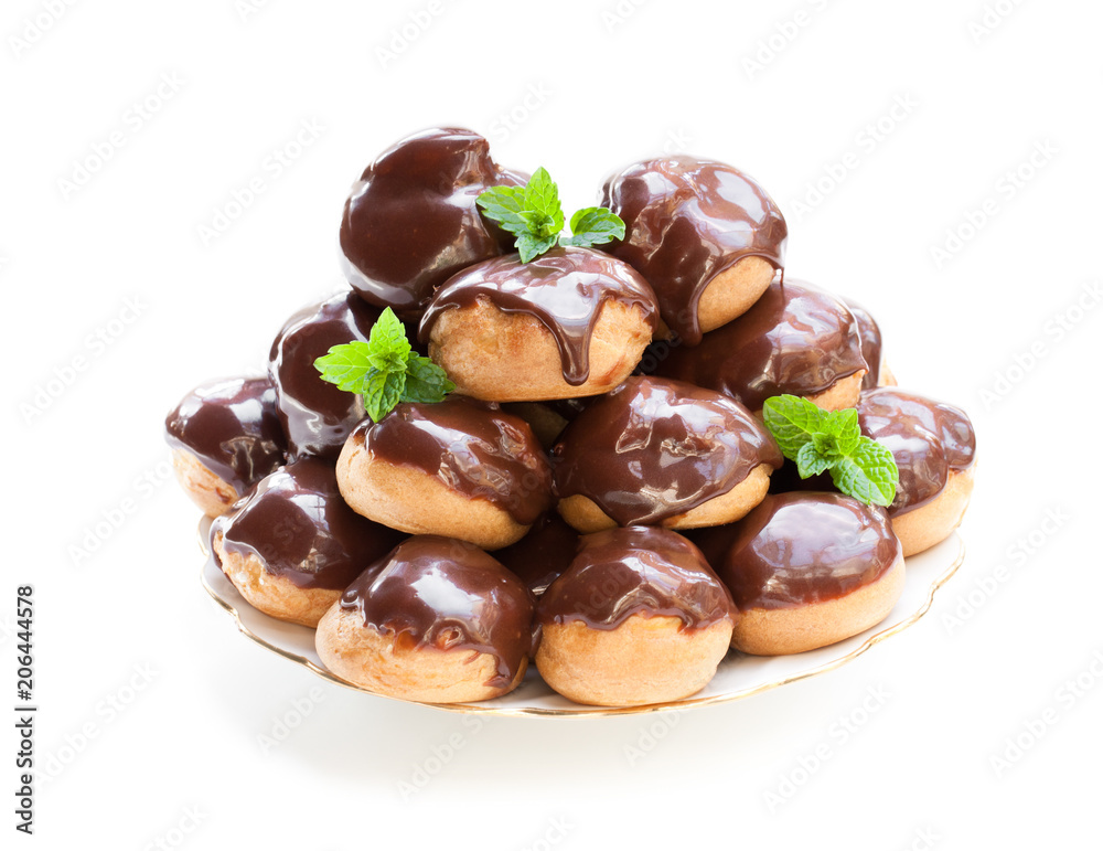 Homemade profiterole choux with chocolate ganache on the plate isolated Homemade profiterole choux with chocolate ganache on the plate isolated
