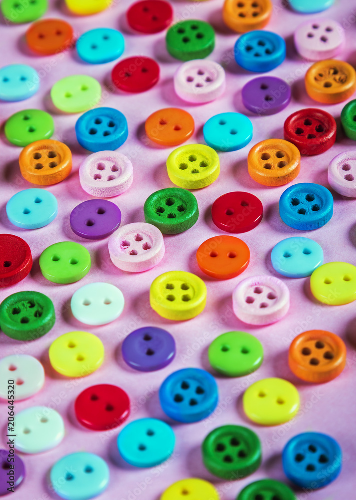 buttons of different colors on a pink background. Pastel shades buttons of different colors on a pink background. Pastel shades