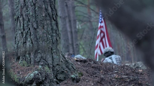 Soldiers in camouflage with combat weapons and in the US in the forest, military concept photo