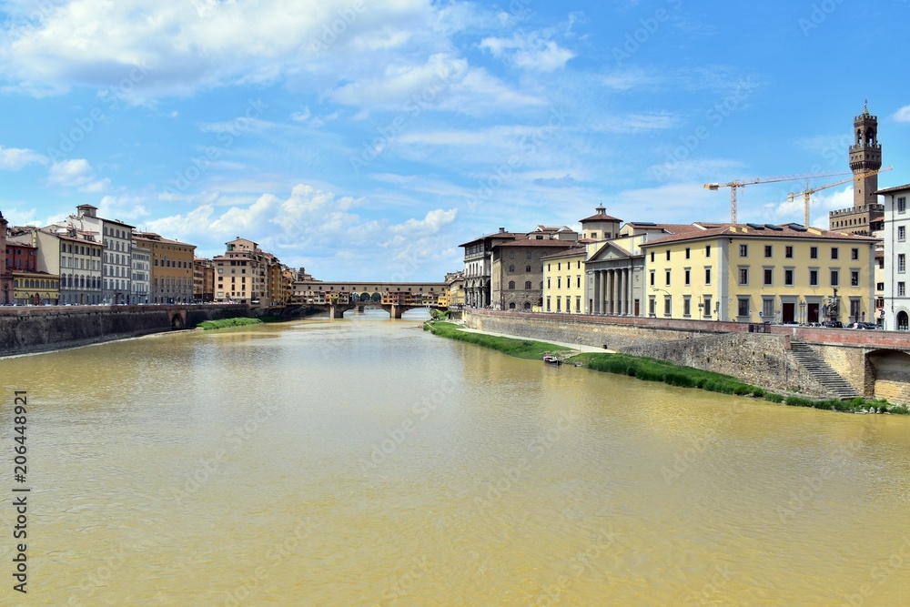 Muddy Arno river from Florence crossing the city of Florence, Italy. Picture was taken from Ponte alle Grazie in May.