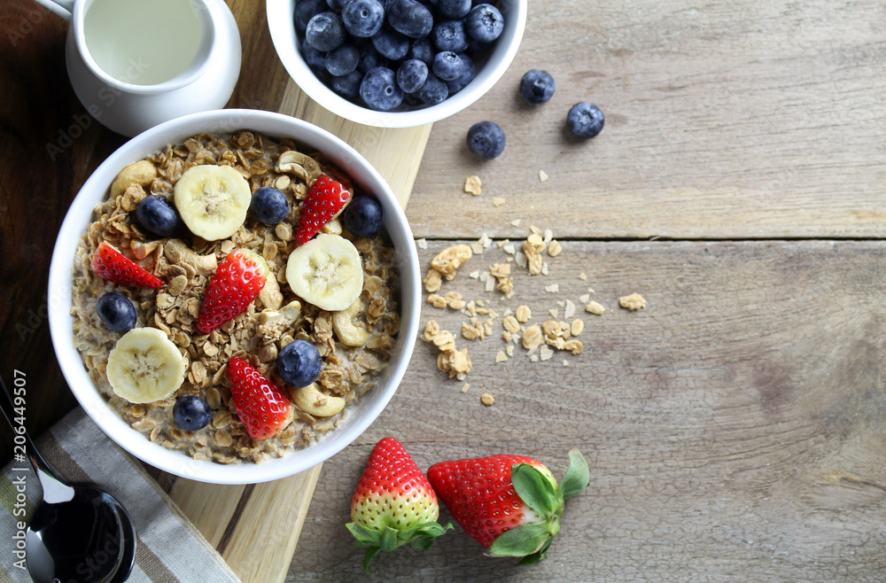 Healthy breakfast, Bowl of yogurt with granola and Fresh fruit on Wood background Healthy breakfast, Bowl of yogurt with granola and Fresh fruit on Wood background