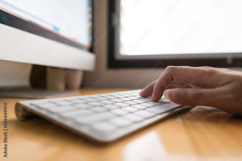 Close up hand business woman working office with computer keyboard. woman writing a blog. Female hands typing on keyboard with wood desk table Close up hand business woman working office with computer keyboard. woman writing a blog. Female hands typing on keyboard with wood desk table
