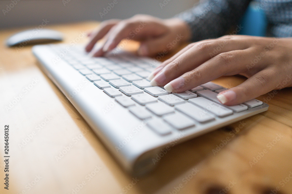 Close up hand business woman working office with computer keyboard. woman writing a blog. Female hands typing on keyboard with wood desk table Close up hand business woman working office with computer keyboard. woman writing a blog. Female hands typing on keyboard with wood desk table