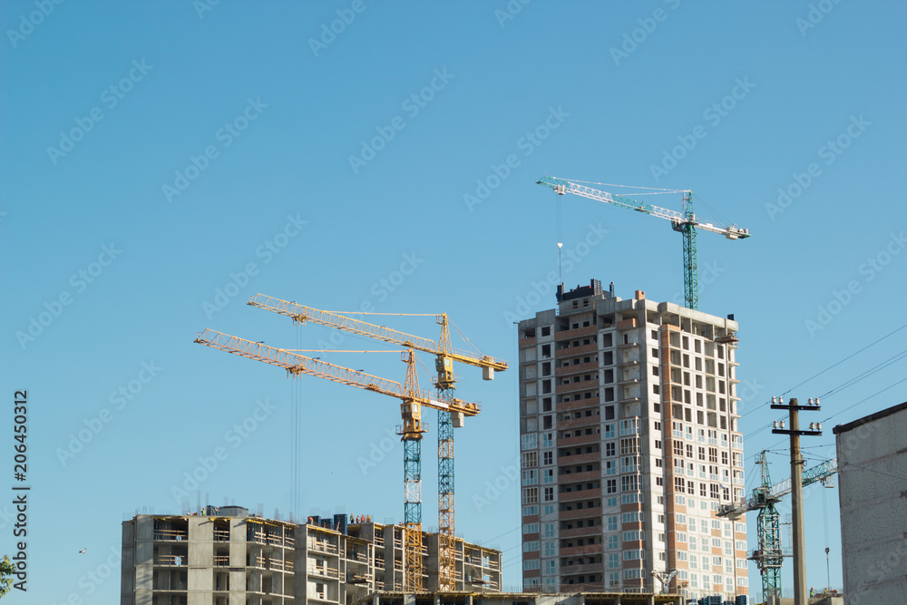 Construction cranes work on site