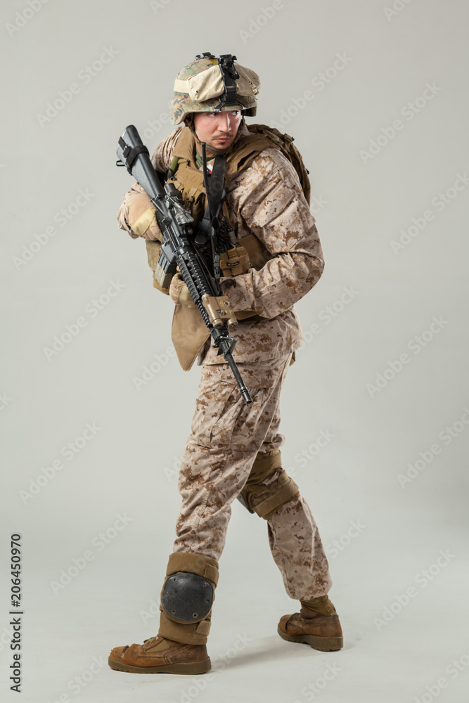 Soldier in camouflage holding rifle Soldier in camouflage holding rifle