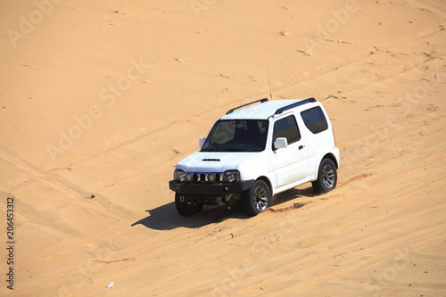 An suv was driving in the desert. © zhengzaishanchu