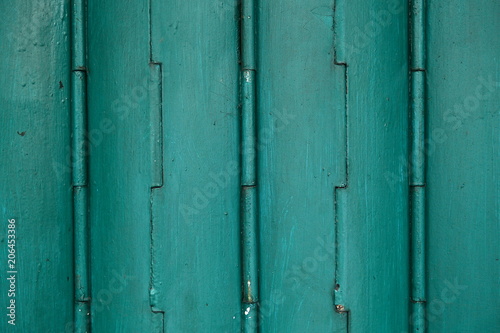backgrond of ancient authentic metal door in colorful shades of green