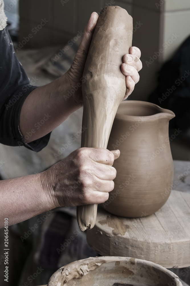 Professional female potter working with clay 