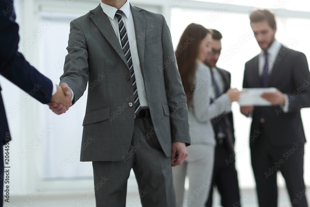 businessman shaking hands to seal a deal with his partner