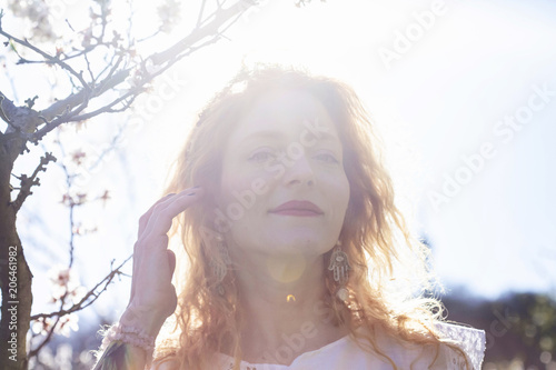 Fototapeta Naklejka Na Ścianę i Meble -  Beautiful woman in spring light garden