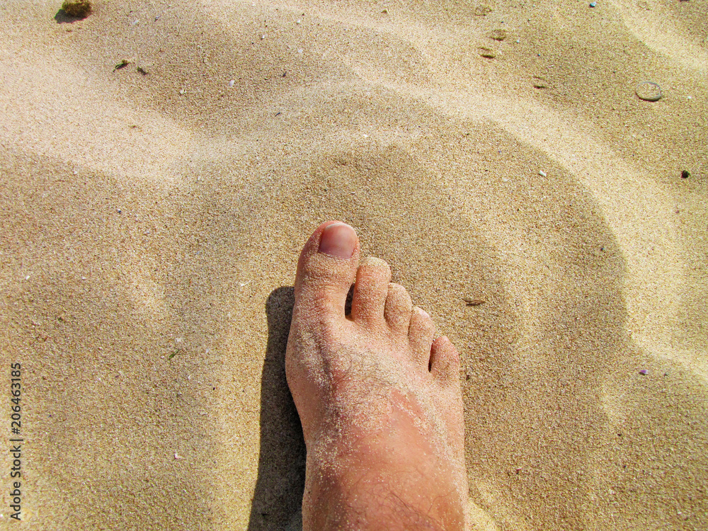 Foot on sea sand, Vacation on ocean beach, Summer holiday.