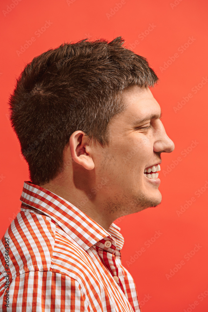 Fototapeta premium The happy business man standing and smiling against red background.