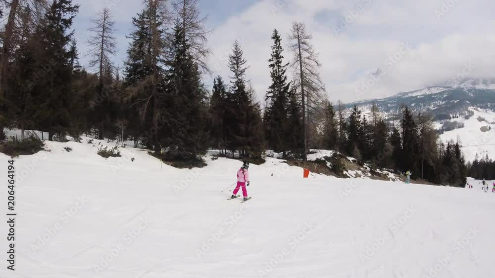 A little girl skiing in mountains, action camera footage A little girl skiing in mountains, action camera footage