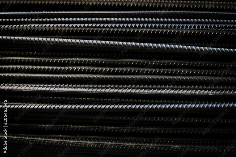 Close up of iron armature rod steel rolled stacked pile background. industrial texture construction concept. Copy space. Stack of heavy metal grey color reinforcing bundle bars, technology pattern Close up of iron armature rod steel rolled stacked pile background. industrial texture construction concept. Copy space. Stack of heavy metal grey color reinforcing bundle bars, technology pattern