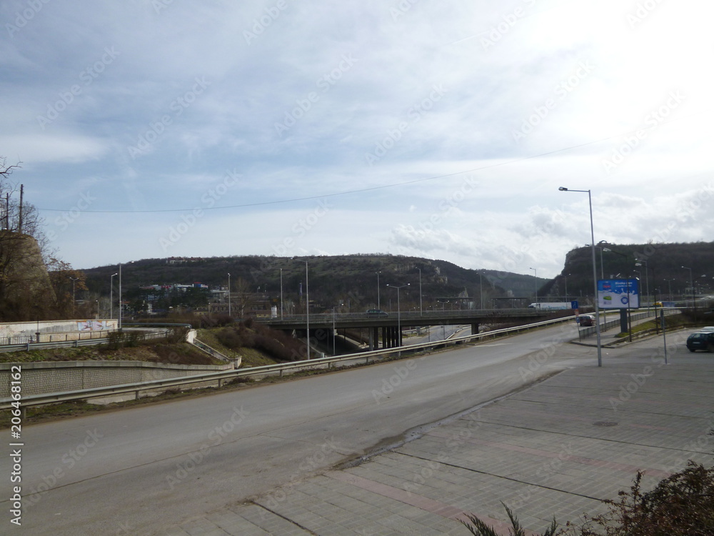 Architecture, built structure, City, cloud-sky, crash barrier, day, direction, empty, highway, mountain, Nature, no people, outdoors, Road, Sign, sky, street, Street Light, symbol, the way forward, Tr Architecture, built structure, City, cloud-sky, crash barrier, day, direction, empty, highway, mountain, Nature, no people, outdoors, Road, Sign, sky, street, Street Light, symbol, the way forward, Tr