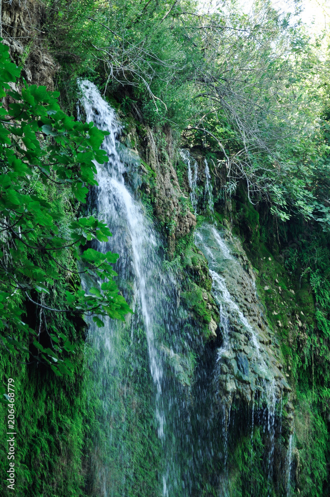 High waterfall on a green slope