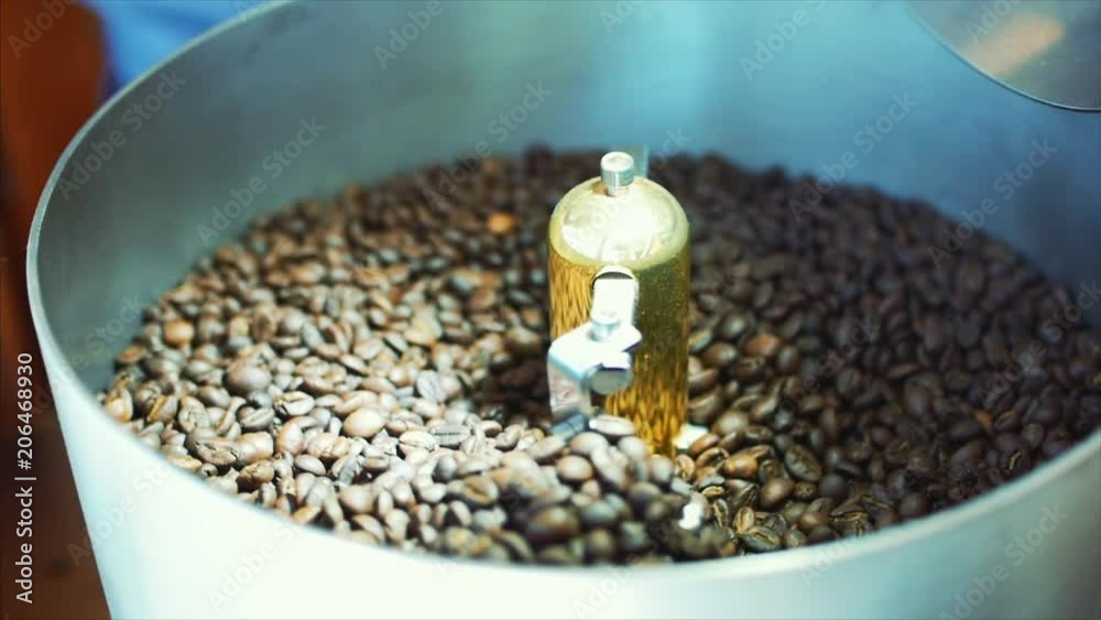 Mixing of roasted coffee. Partial removal of bad grains. The roasted coffee beans got on the mixer sorting by a professional machine. Slow motion. Mixing of roasted coffee. Partial removal of bad grains. The roasted coffee beans got on the mixer sorting by a professional machine. Slow motion.