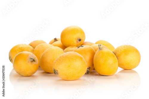 Fresh orange Japanese loquats heap isolated on white background.