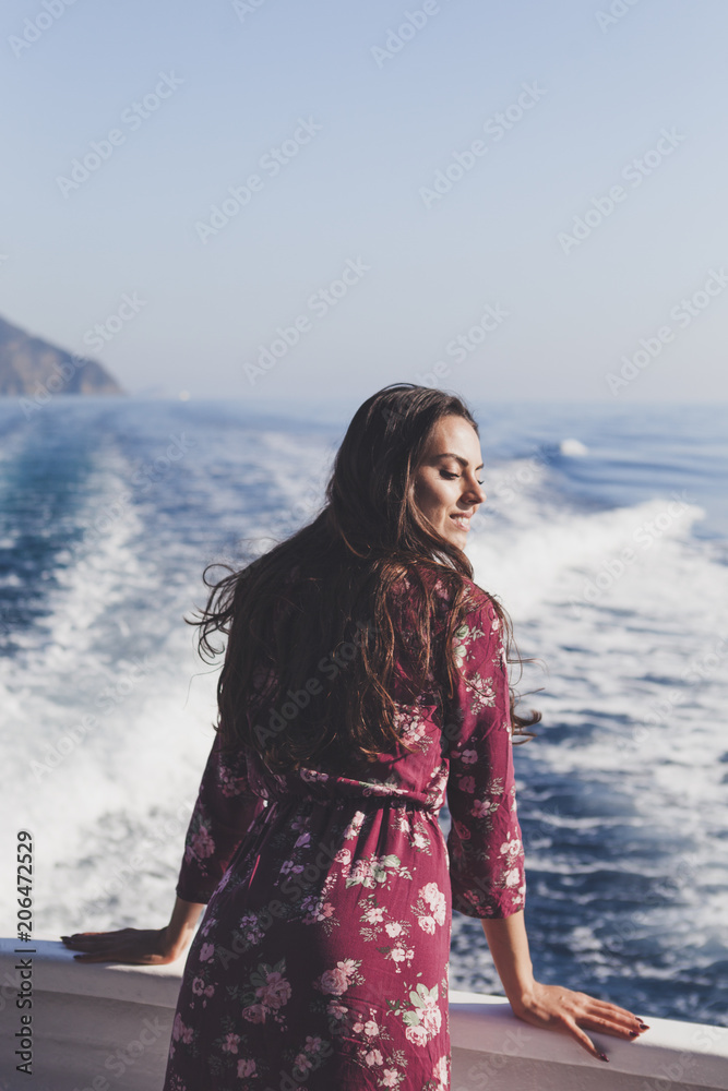Happy young amazing woman wearing relaxing on the yacht in Cinque Terre, Italy, Ligurian Sea Happy young amazing woman wearing relaxing on the yacht in Cinque Terre, Italy, Ligurian Sea