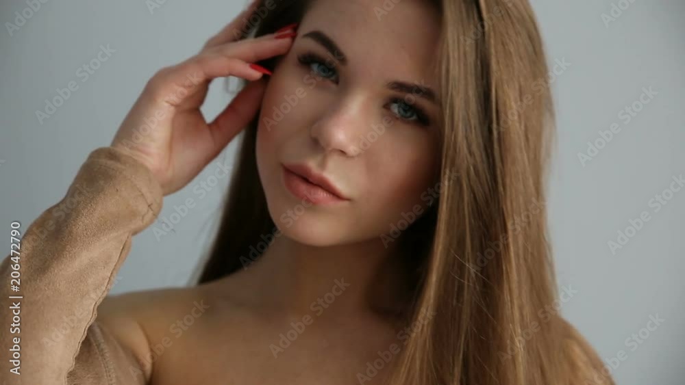 beautiful happy girl posing positively against a gray wall beautiful happy girl posing positively against a gray wall