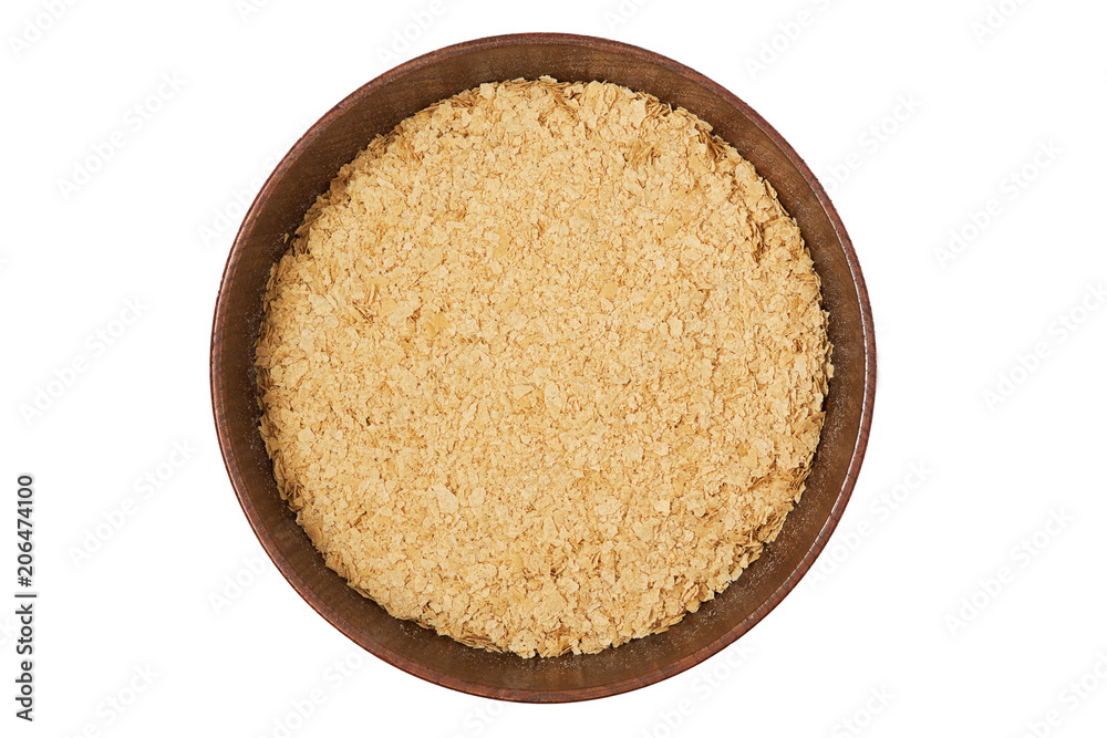 Nutritional brewers yeast flakes in wooden bowl isolated on white background. Top view Nutritional brewers yeast flakes in wooden bowl isolated on white background. Top view