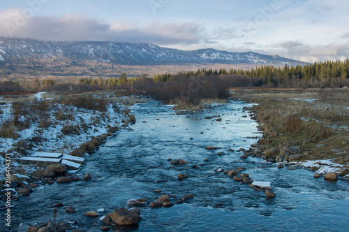 a mountain stream flows at the foot of the Zigalga Range