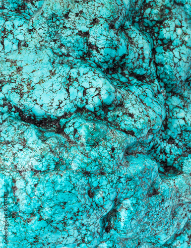 The big piece of a natural stone of turquoise like a background or wallpaper.