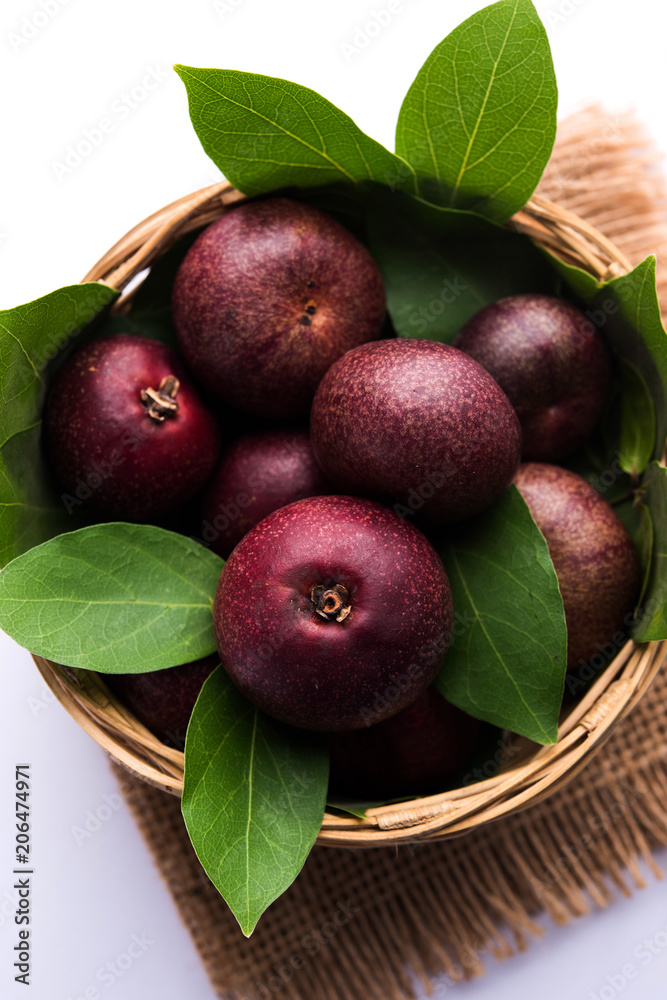 Fresh Kokum or Garcinia indica fruit from India isolated over white or in  cane basket with leaves. selective focus Stock Photo | Adobe Stock