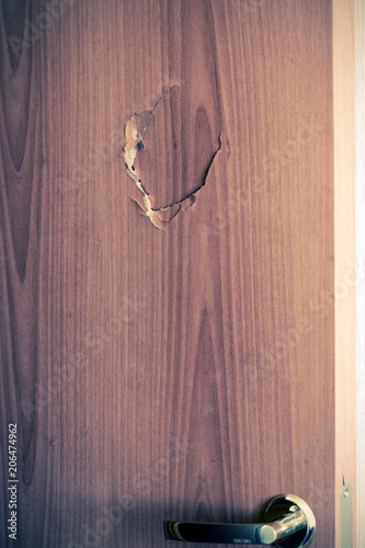 Broken door with golden handle and lock, side view