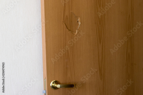 Broken door with golden handle and lock, side view