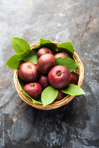 Fresh Kokum or Garcinia indica fruit from India isolated over white or in cane basket with leaves. selective focus