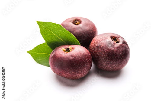 Fresh Kokum or Garcinia indica fruit from India isolated over white or in cane basket with leaves. selective focus photo